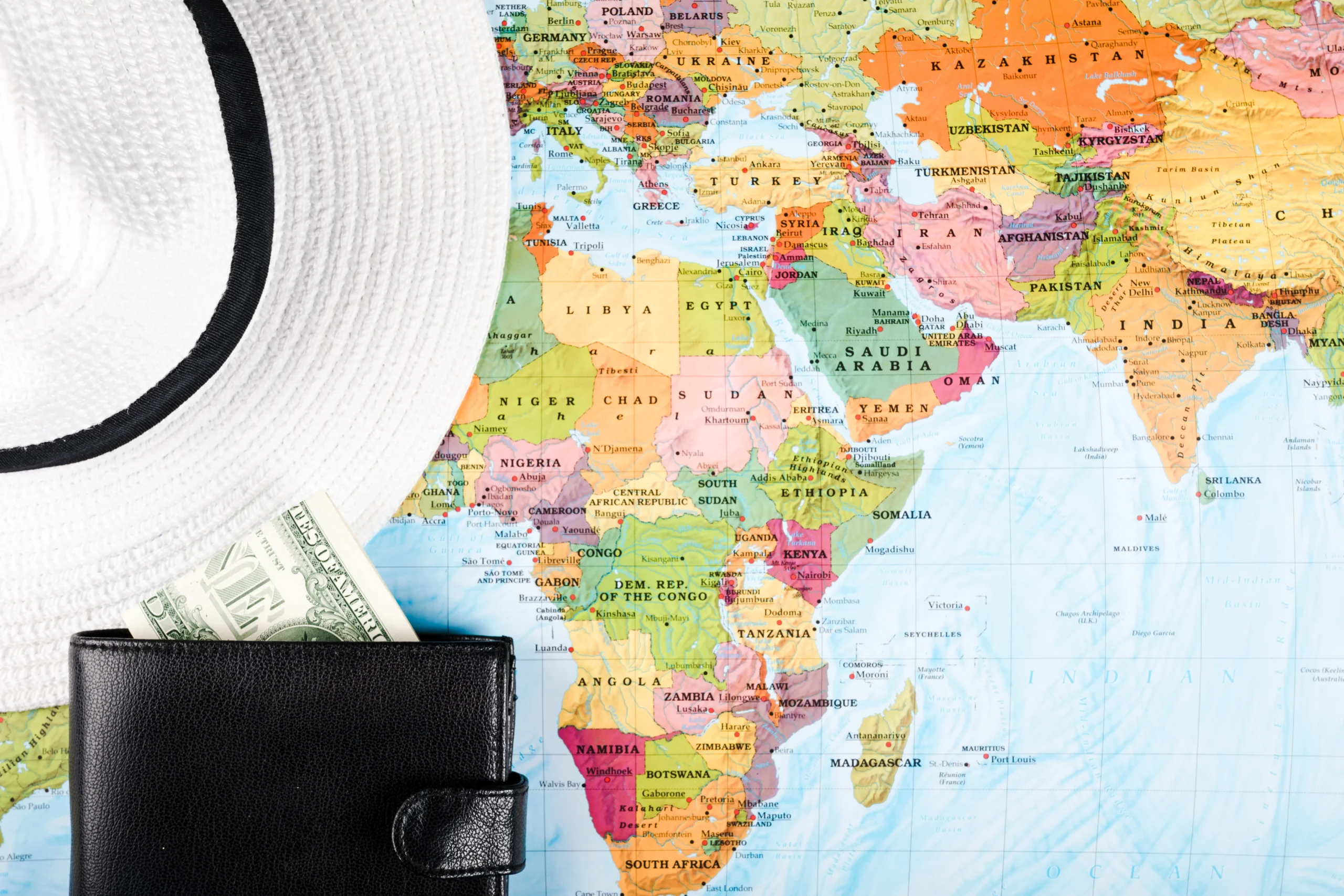 elevated view hat wallet with banknotes map scaled