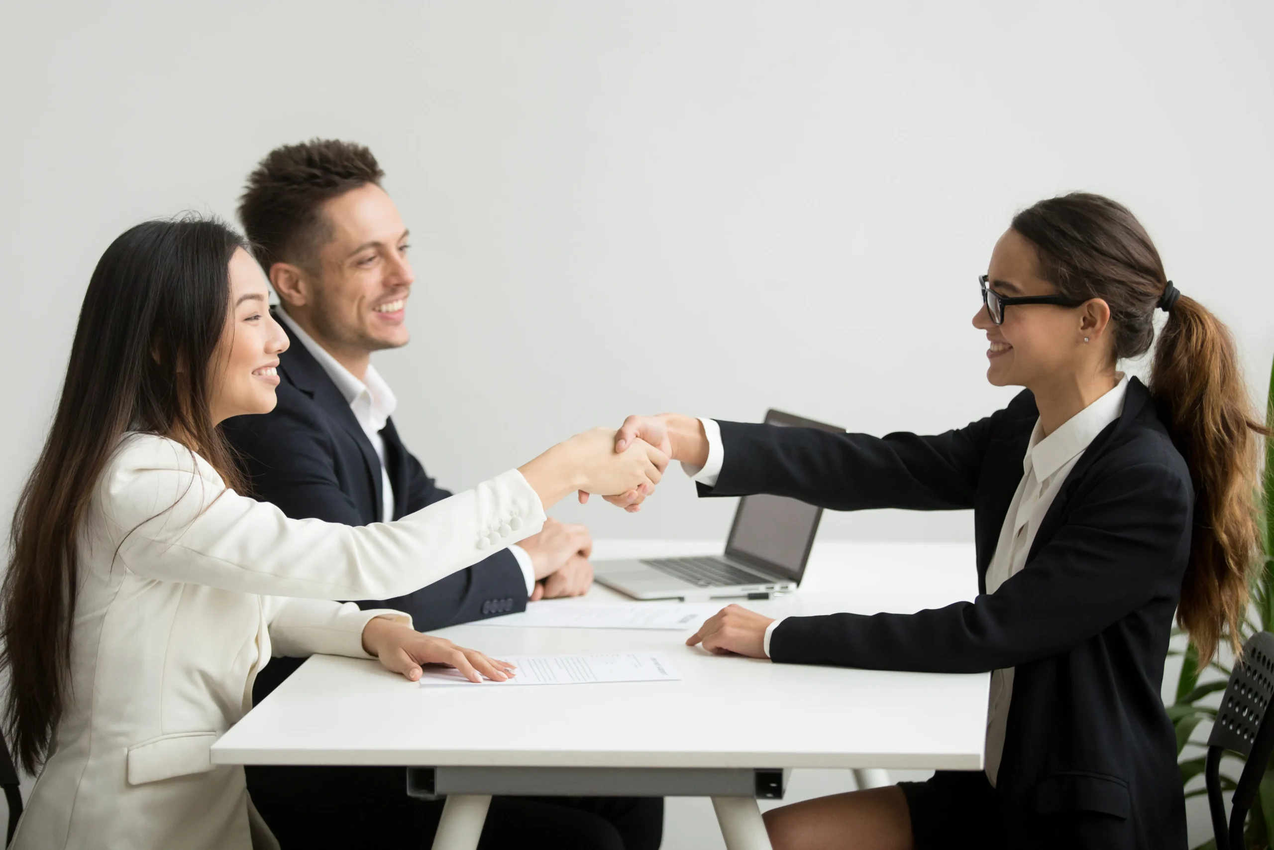 smiling diverse businesswomen shake hands group meeting deal concept scaled